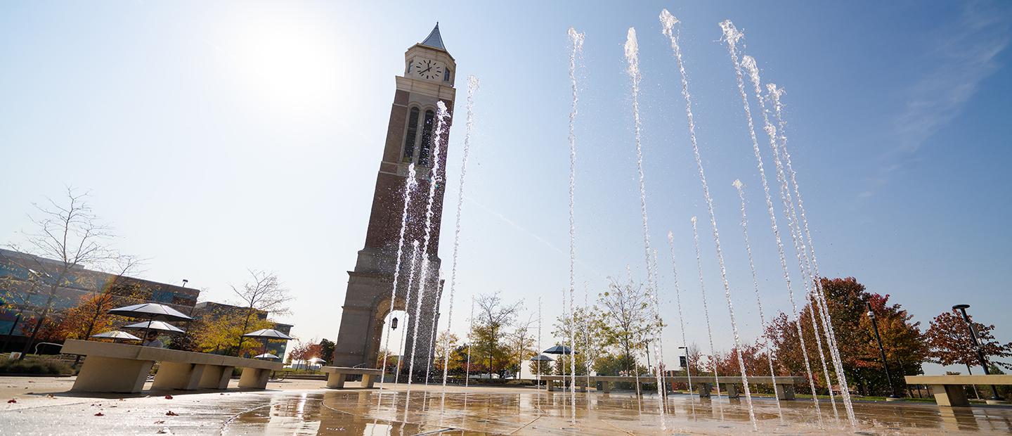 Tall streams of water in a fountain in front of Elliott Tower on Oakland University's campus.